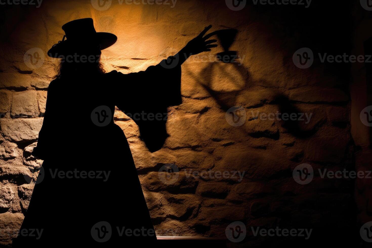 A dramatic image showcasing the silhouette of a witch cast by candlelight onto an old stone wall. photo
