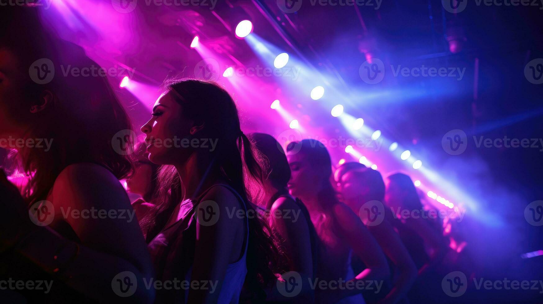 Group of people having fun and singing along at the concert photo