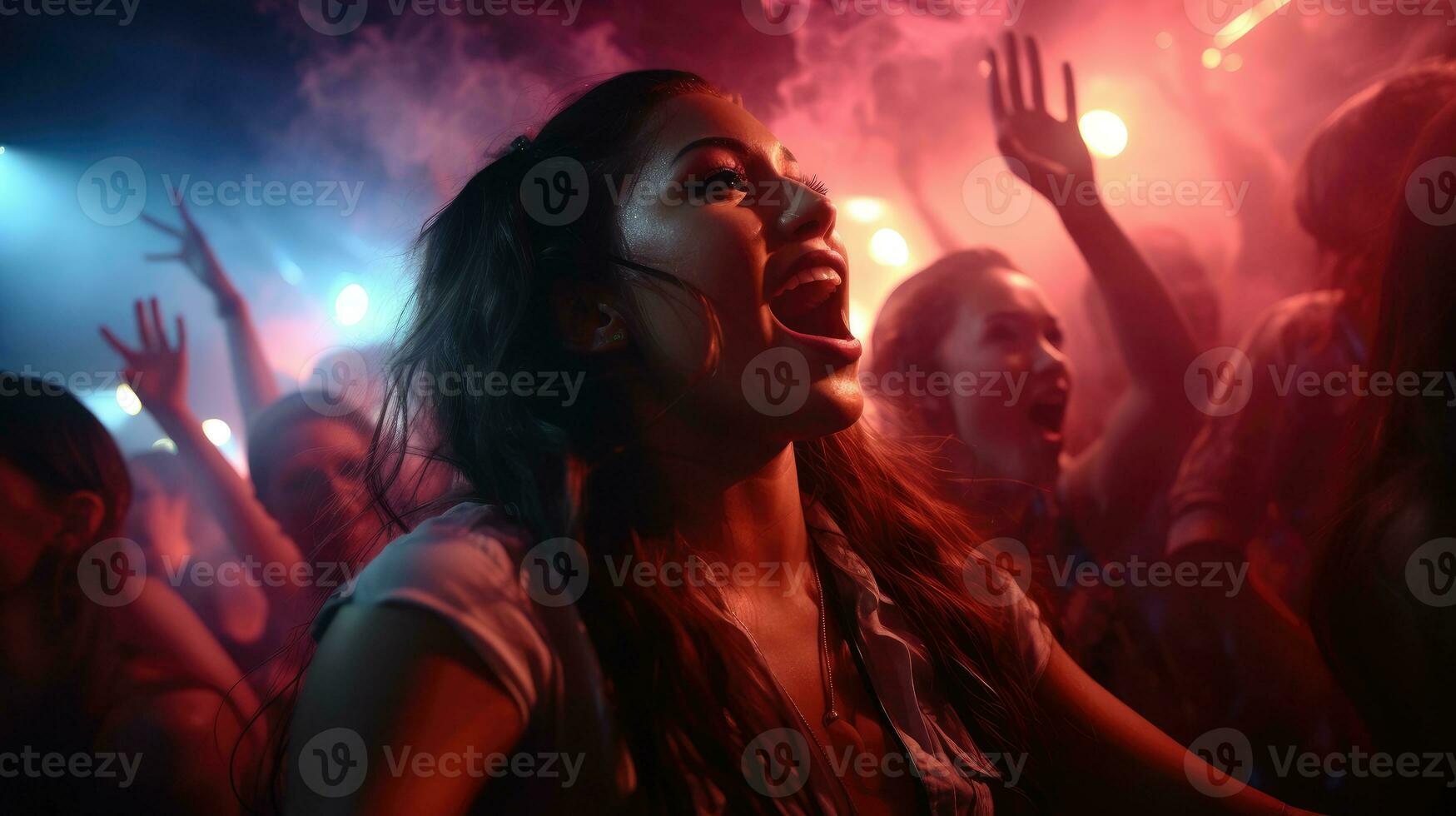 Group of people having fun and singing along at the concert photo
