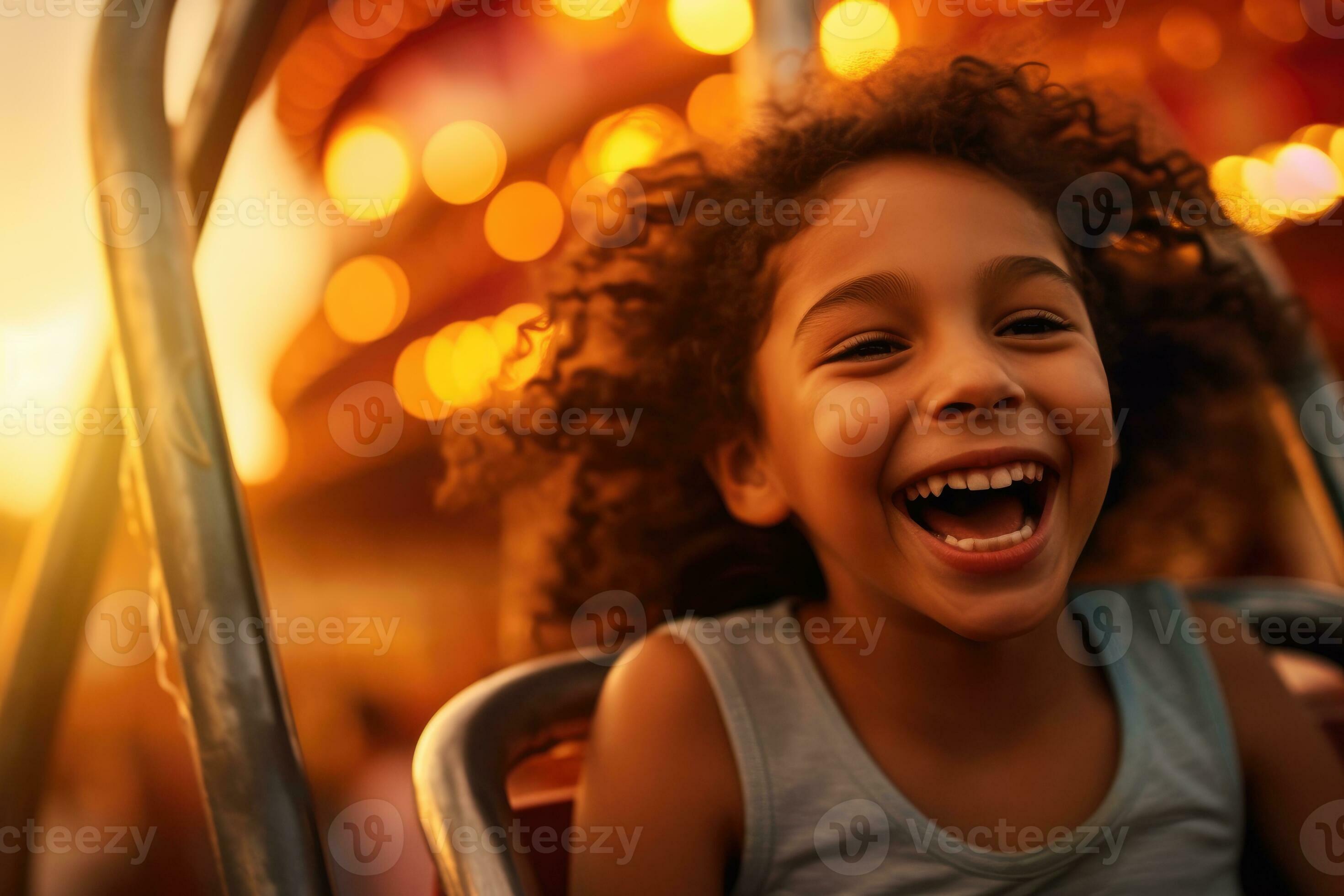 Close-up shot of a little girl laughing and having fun at the amusement ...