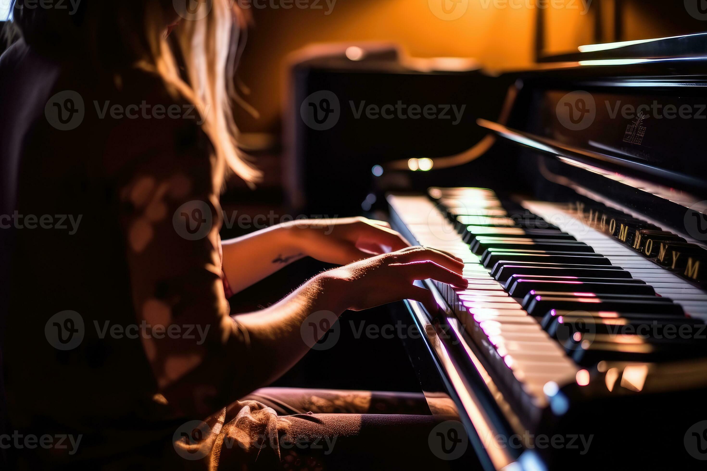 A close - up shot of a woman playing the piano in a dimly lit music