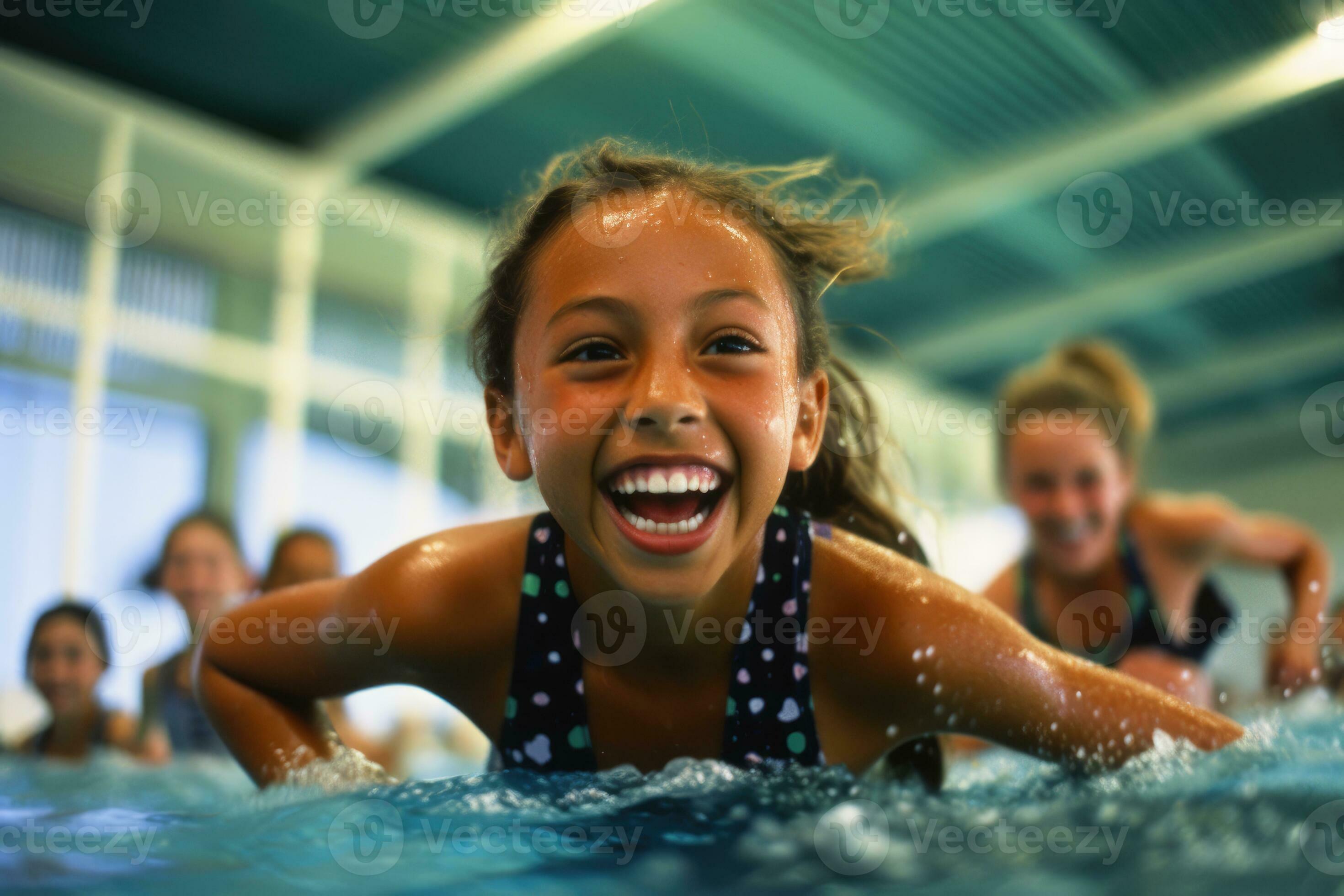 Young child girls as they participate in a swimming lesson at a pool