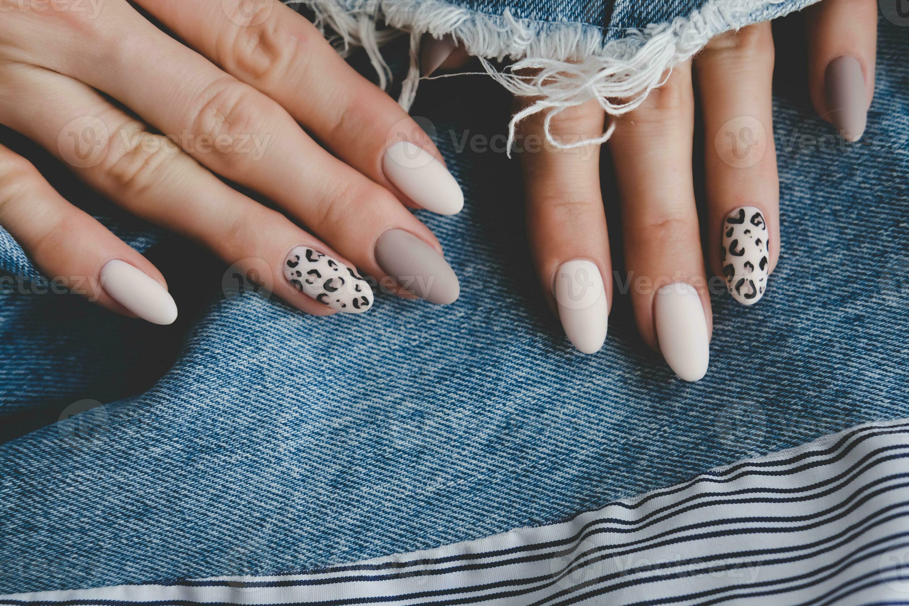 Beautiful female hands with manicure on the background of denim