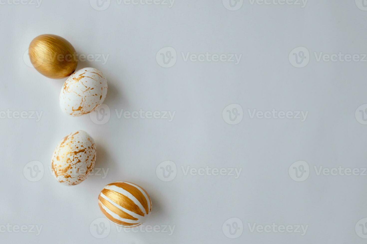 Top view Easter eggs painted with gold paint in various patterns . White background. Space for copy. photo