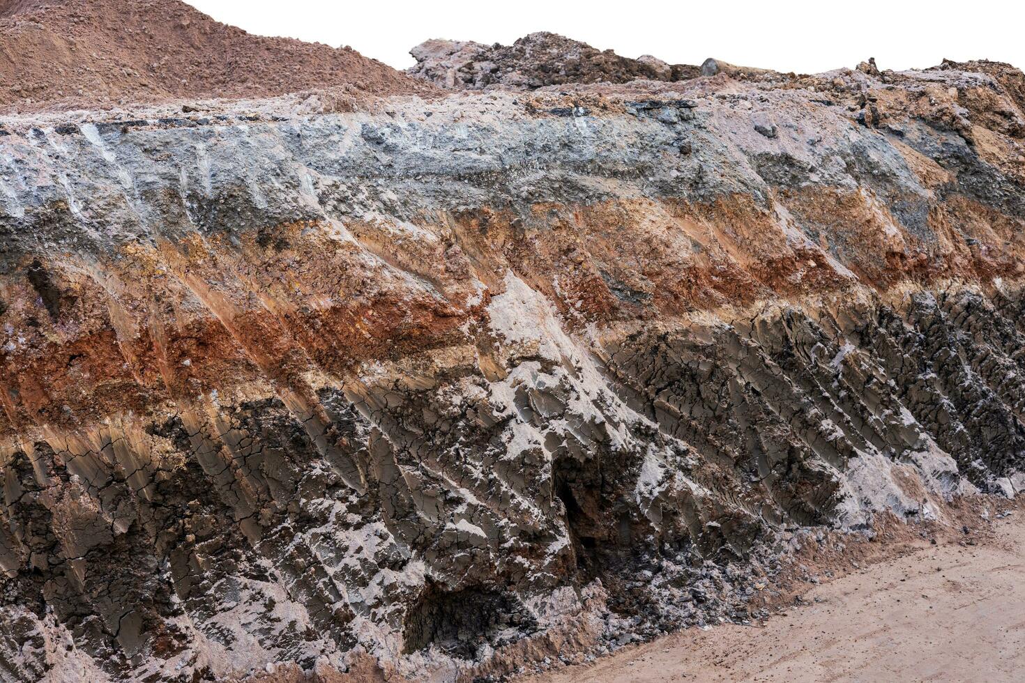 A cross-sectional view of the layer of soil beneath the paved road that was excavated. photo