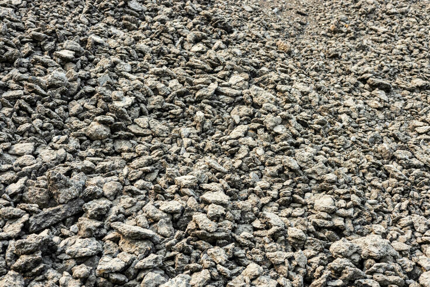 Heaps of bits and pieces of asphalt stones taken from demolished roads. photo