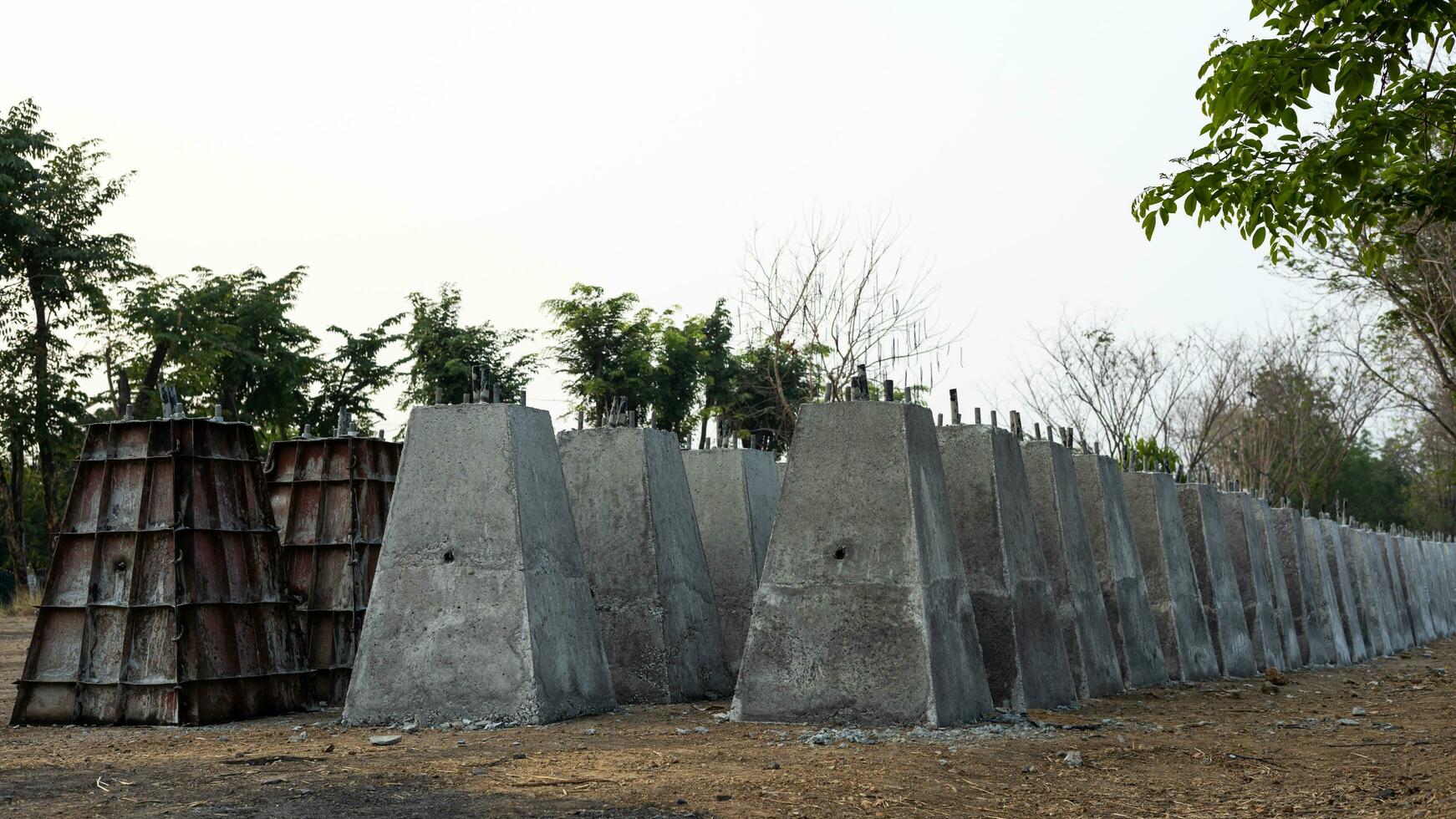 Numerous concrete pillar bases, which were built by cement casting in a steel box and lined up in rows. photo