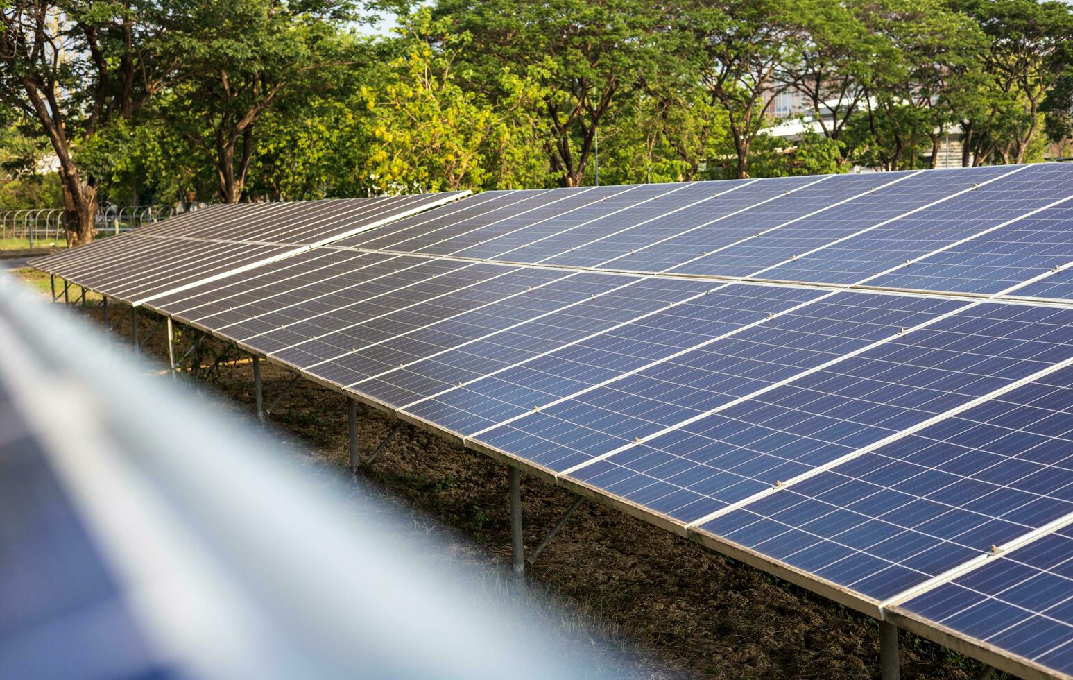 Close-up view of rows of large old blue solar panels, used as 