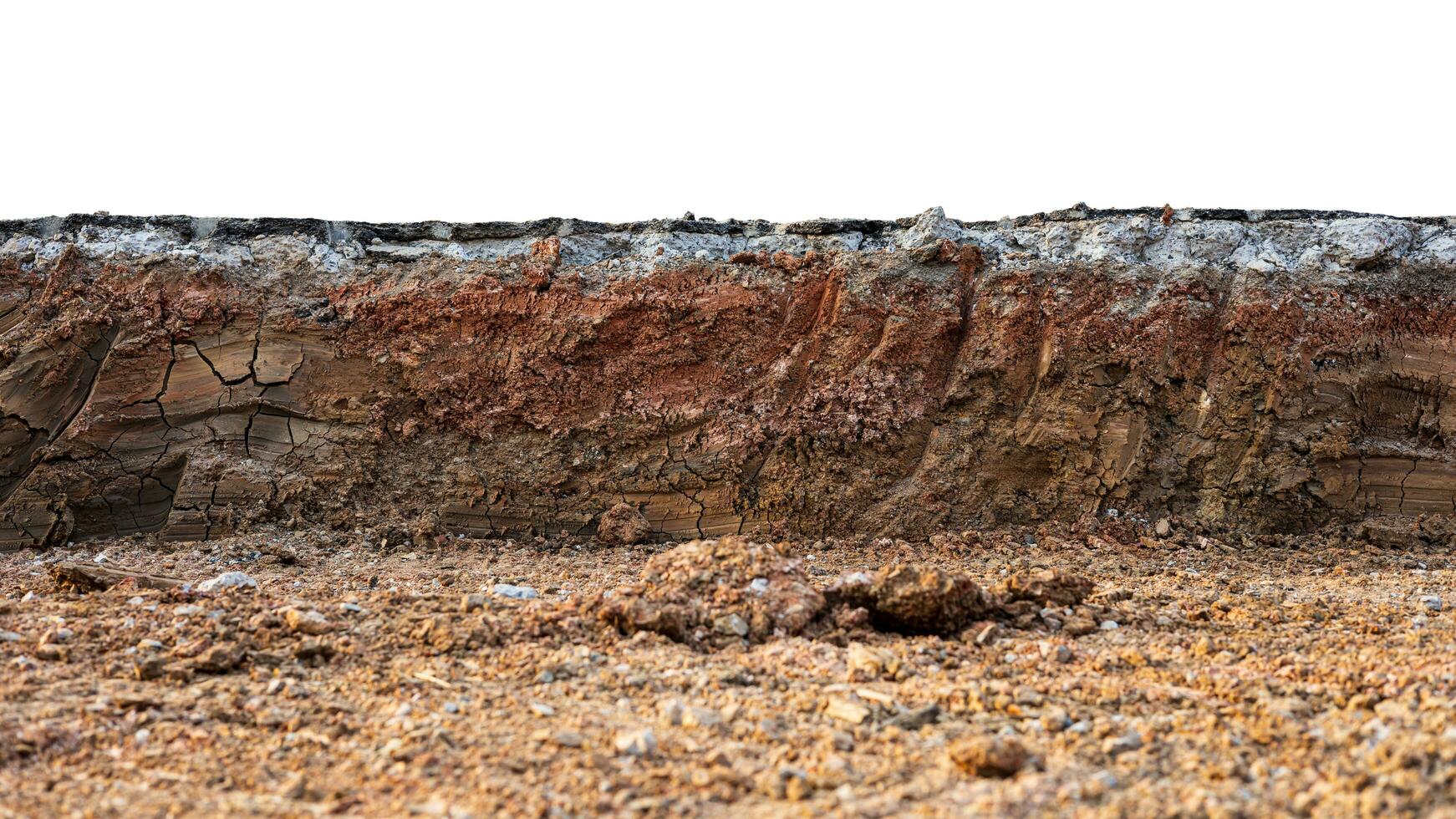 A low-angle view through the mound to the cross-section of the soil layer beneath an asphalt road. photo