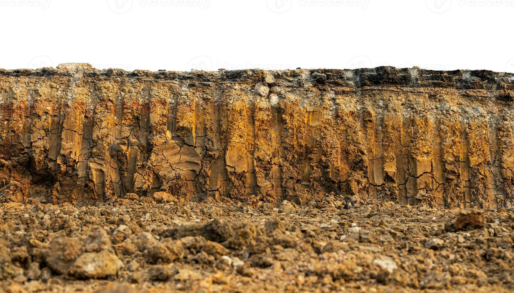 A low-angle view through the mound to the cross-section of the soil layer beneath an asphalt road. photo