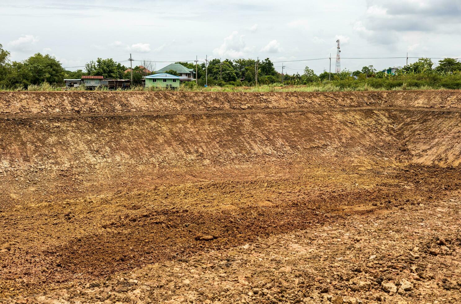 A background view of the shoreline, a mound of dirt dug into a canal or a large pond. photo