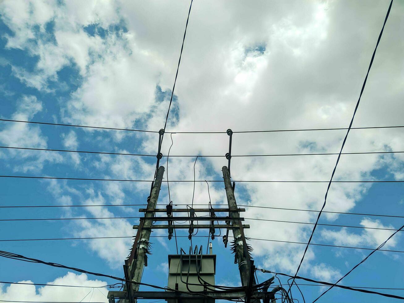 electric poles with wires connected sky background photo