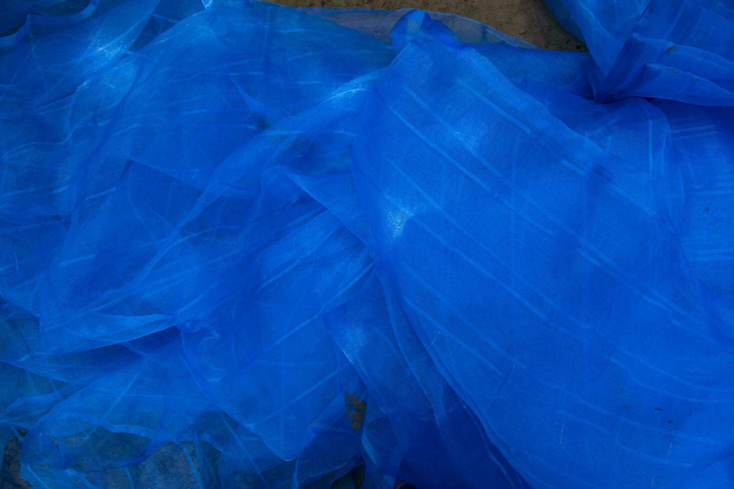 Translucent blue net fabric can be used as a background wallpaper photo