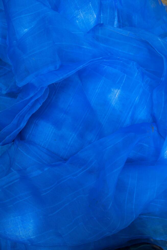 Translucent blue net fabric can be used as a background wallpaper photo