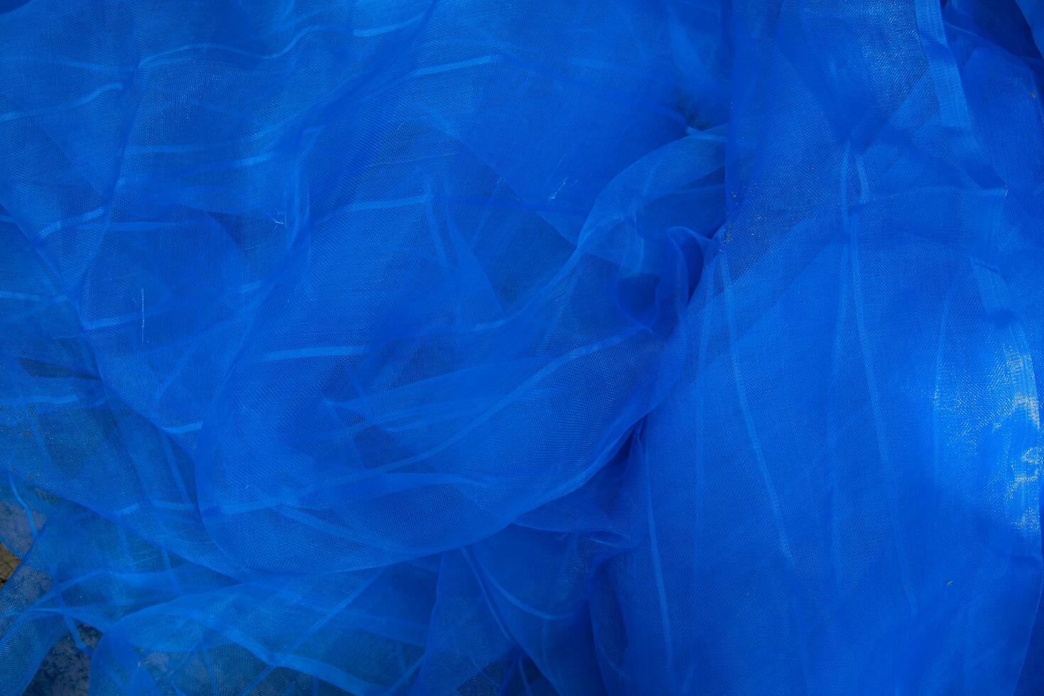 Translucent blue net fabric can be used as a background wallpaper photo