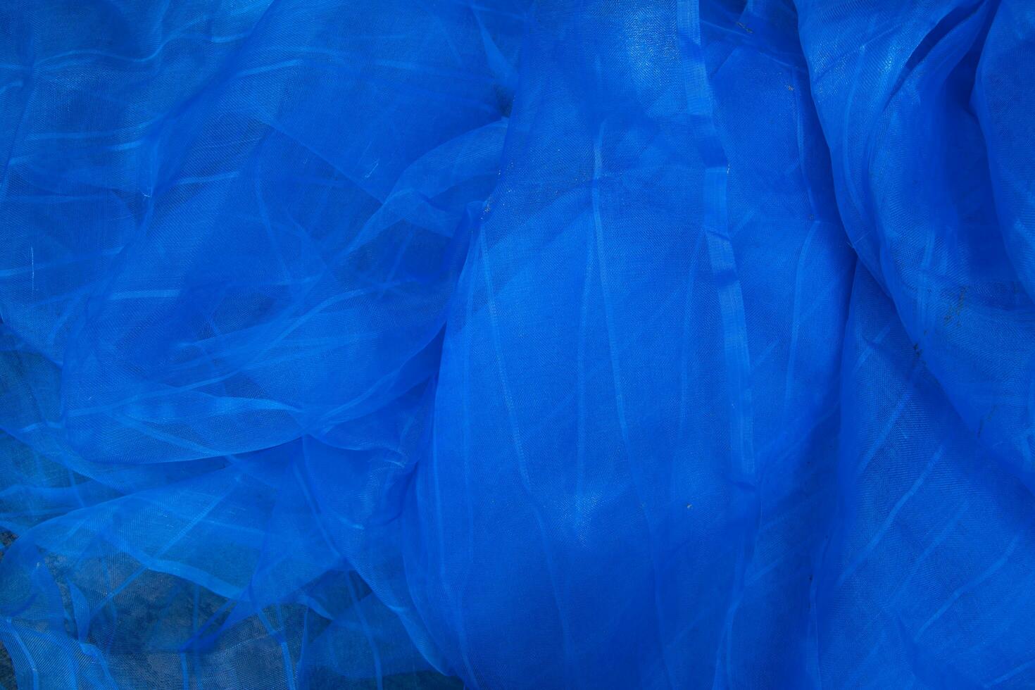 Translucent blue net fabric can be used as a background wallpaper photo