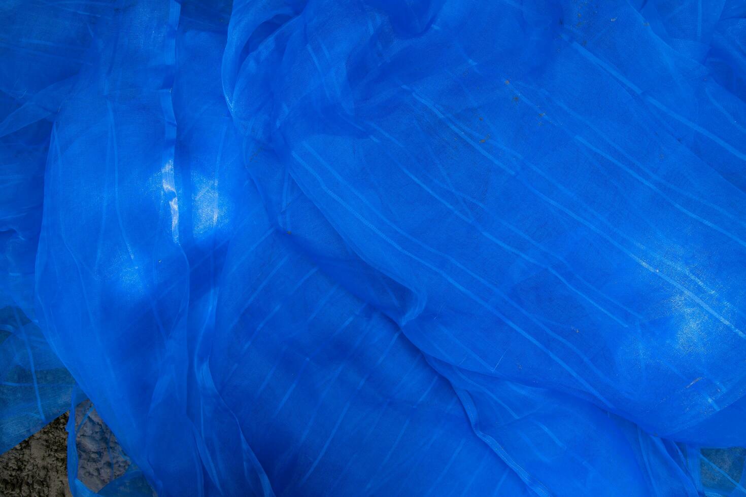 Translucent blue net fabric can be used as a background wallpaper photo