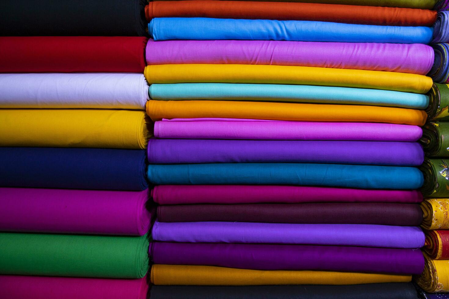 Artistic variety shade tone colors Textile Fabrics stacked on retail Shop Shelf to sale photo