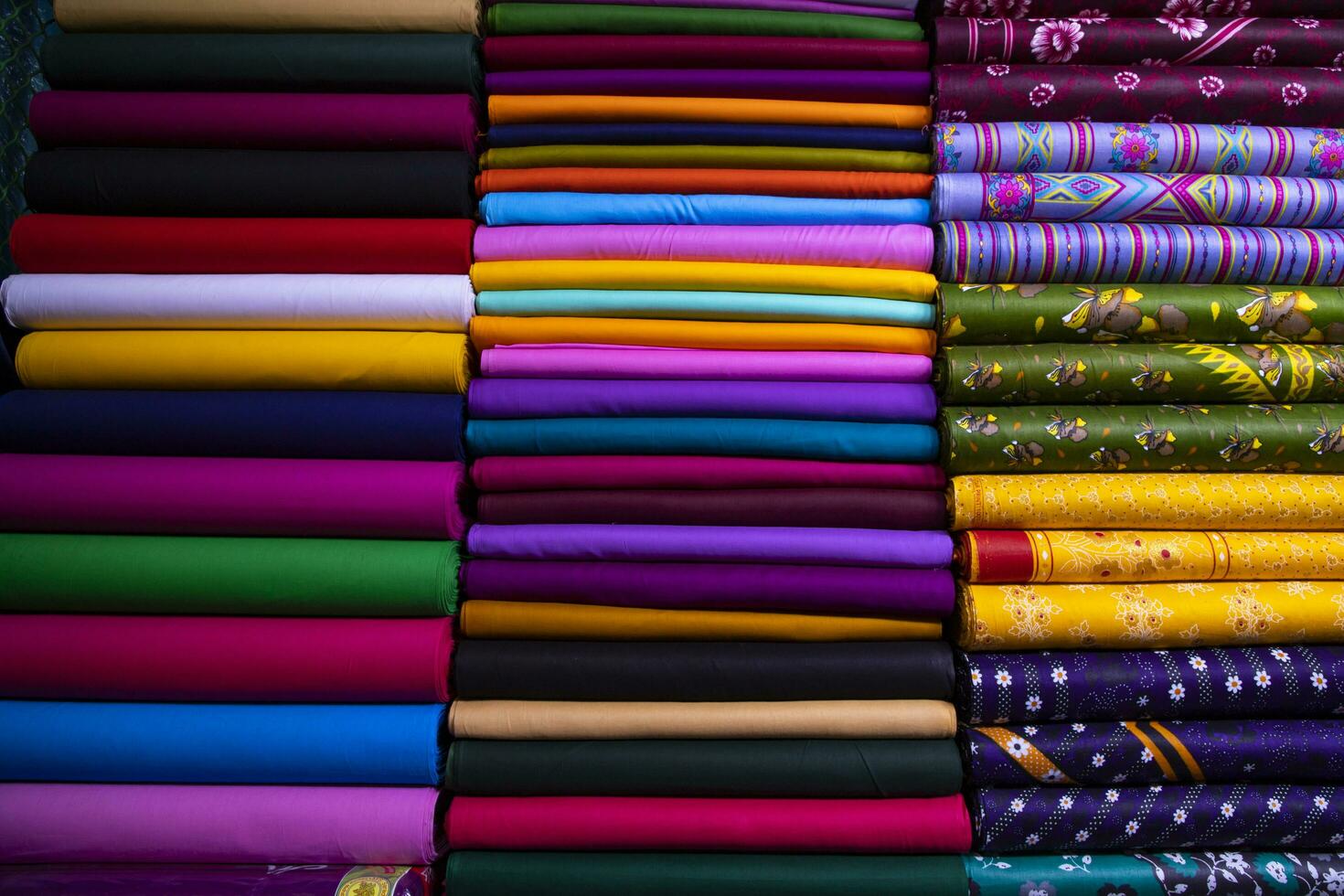 Artistic variety shade tone colors Textile Fabrics stacked on retail Shop Shelf to sale photo