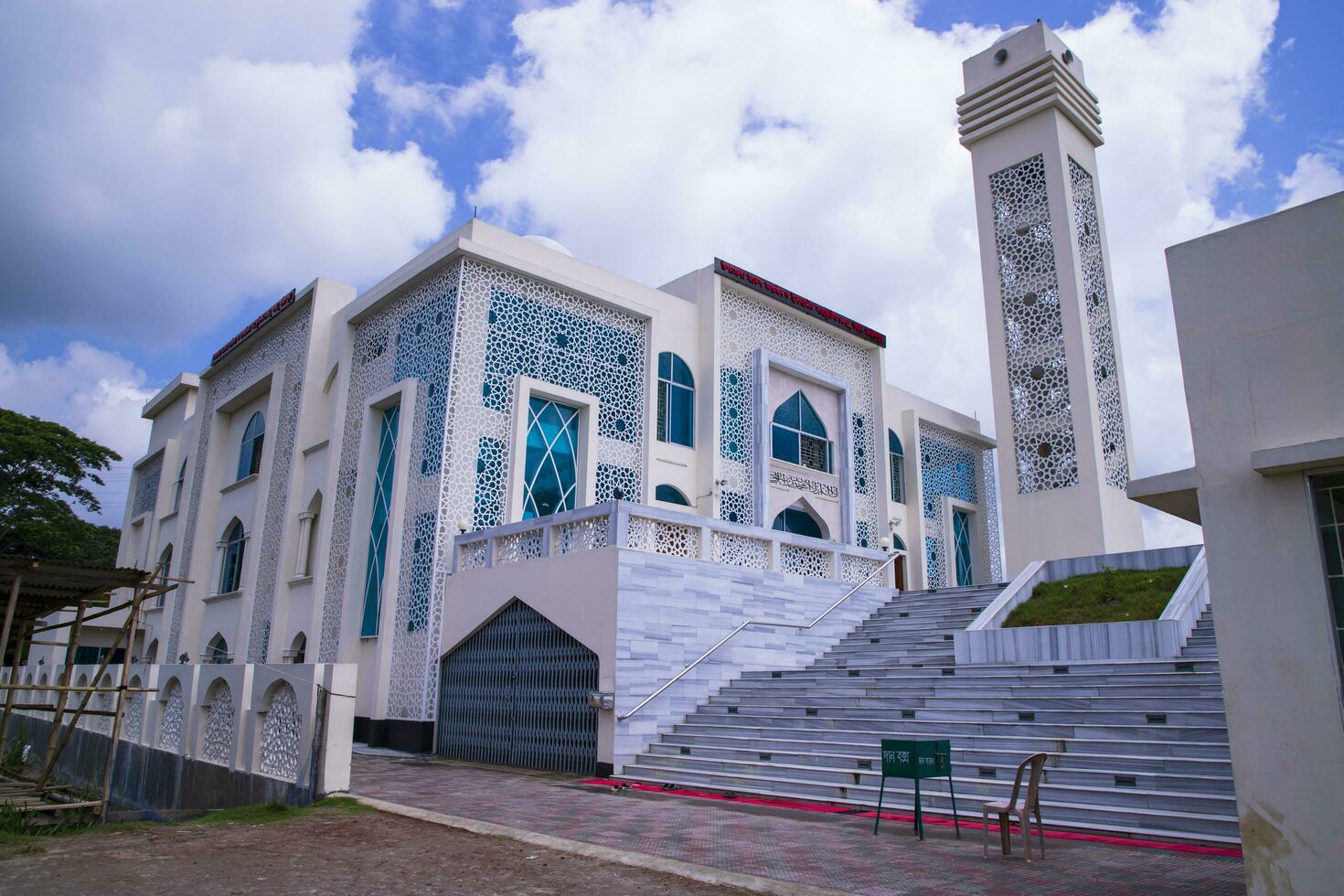 Most Beautiful architecture Model Mosque in Bangladesh with a White cloudy Blue sky photo