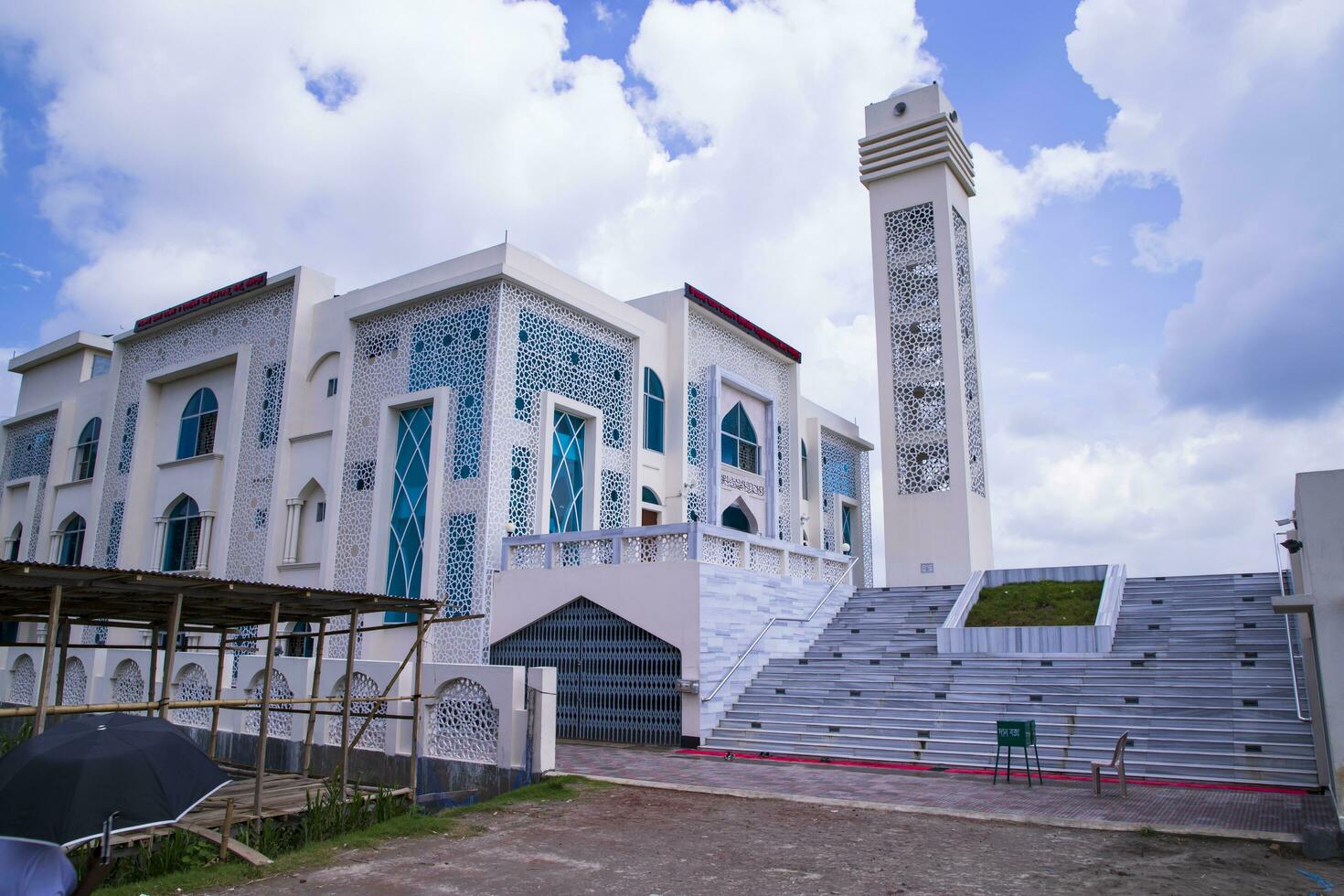 Most Beautiful architecture Model Mosque in Bangladesh with a White cloudy Blue sky photo