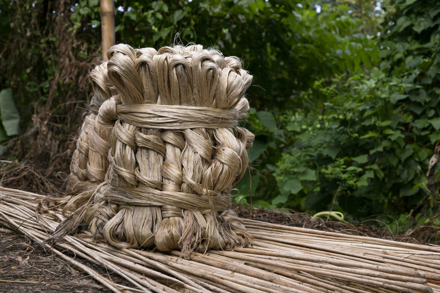 A thick brown  bundle of raw jute has on the ground photo