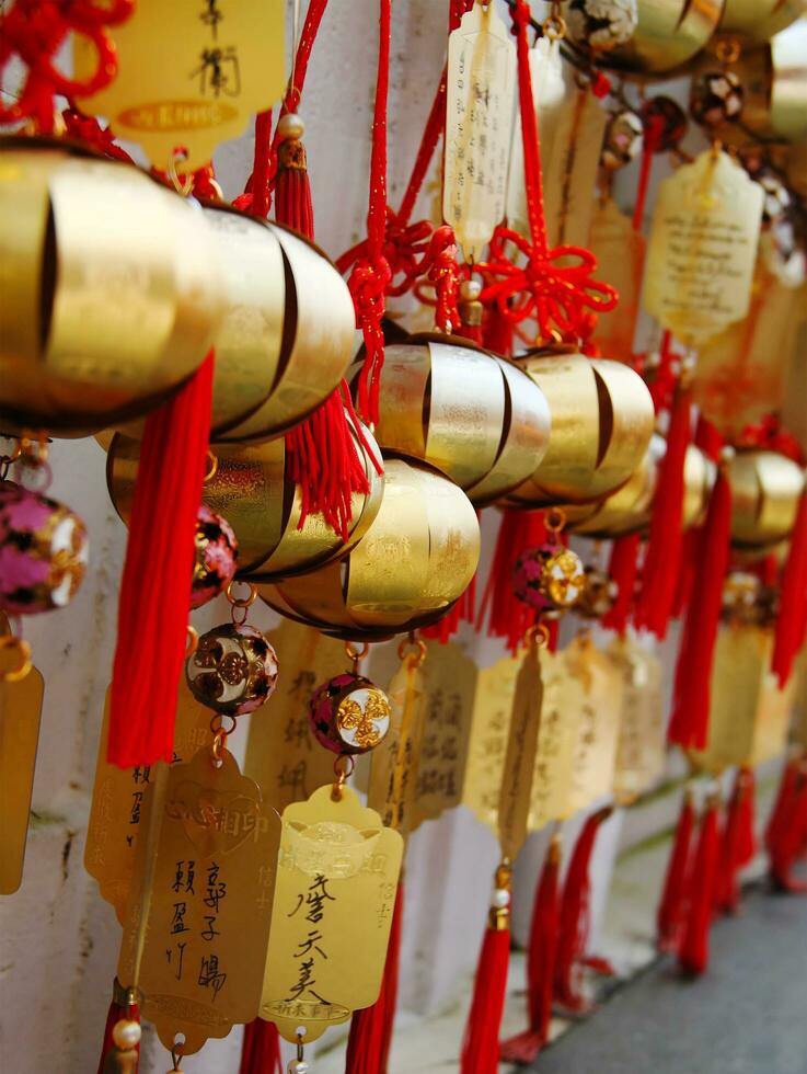 Chinese whising golden bells with greeting word or lucky word people wish and hang on tope for pray applicable for banners, posters, information graphics, prints layout covering books, magazine pages photo