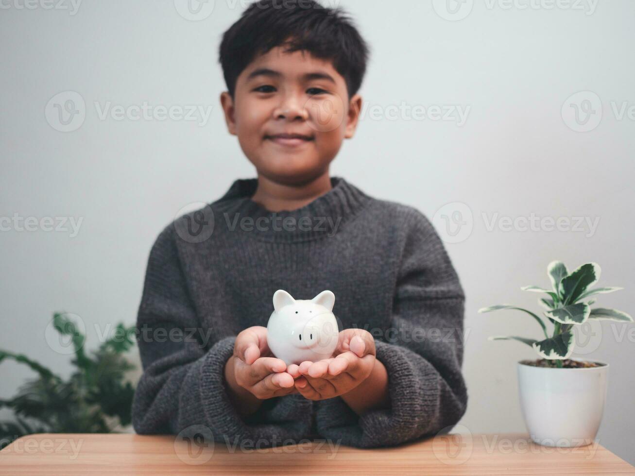 A boy holding piggy bank. Learning financial responsibility and projecting savings. savings concept. investment concept. photo