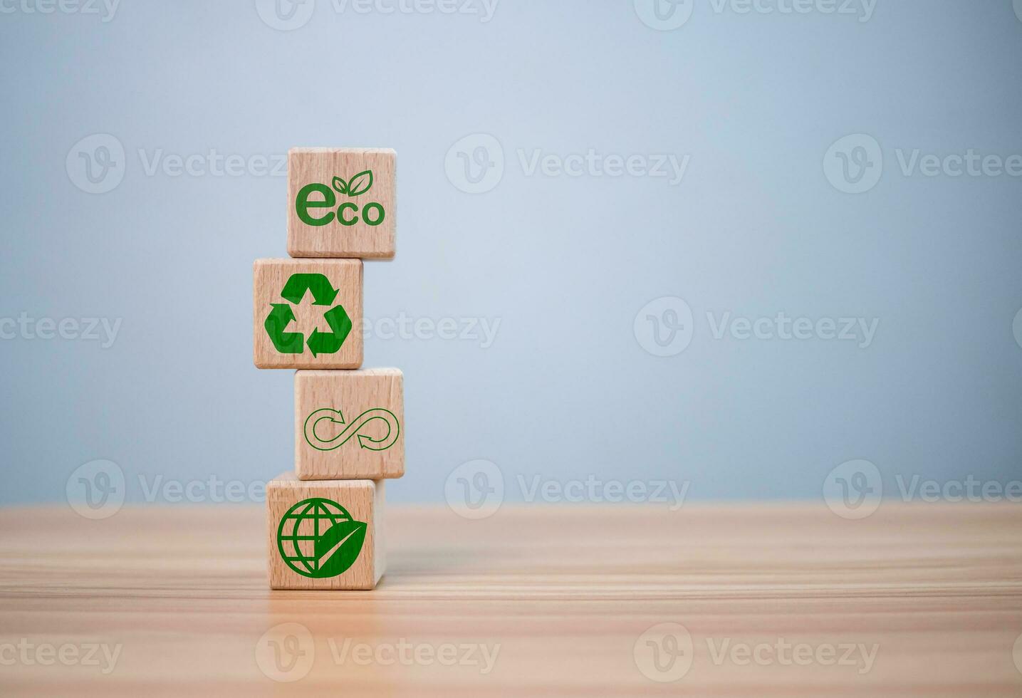 concept of waste reduction. Pollution. Reuse. Efficient use of resources. Environmental protection sign by recycling on wooden blocks placed on wooden table background. photo