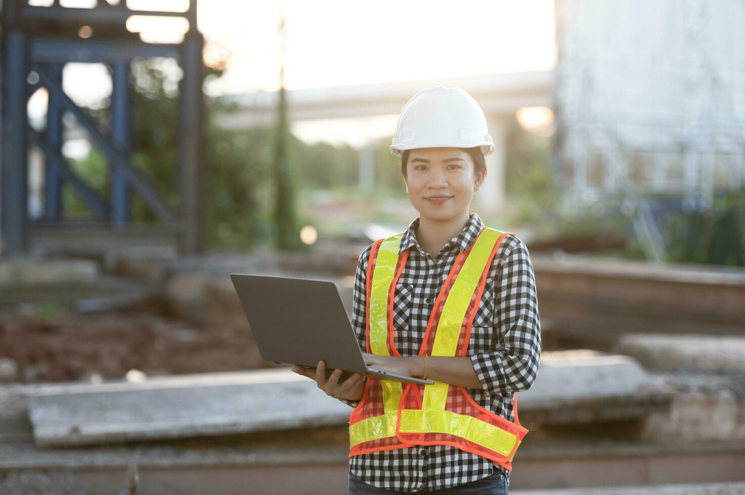 construction engineer Asian female architect with tablet computer at expressway construction site young woman watching expressway construction site photo