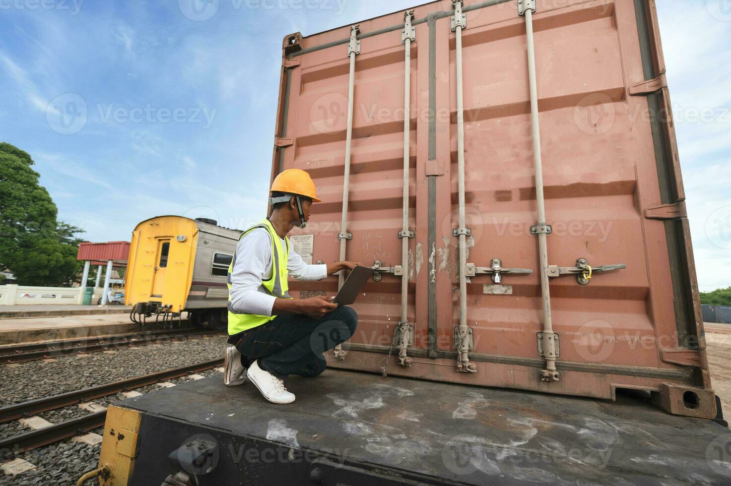 Engineer inspects container train of transport company Distribution and transportation of goods by rail A container train passing through an industrial area photo