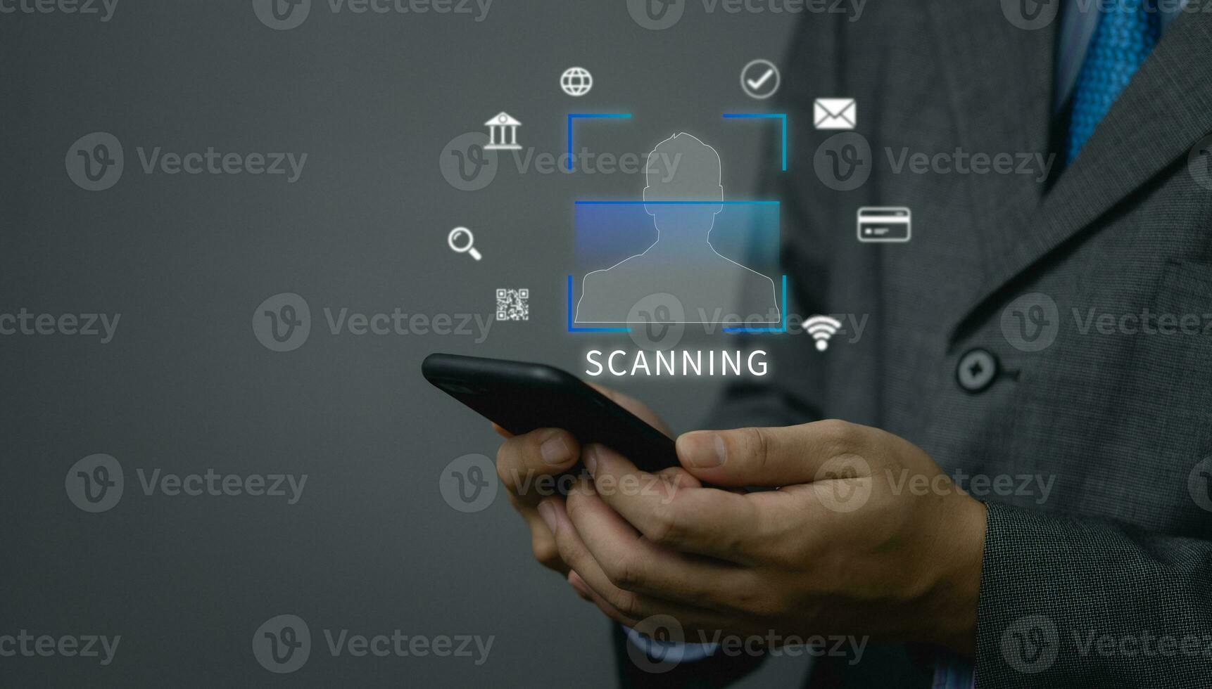 businessman holding mobile phone icon, scan face and identity verification.Payment and anti-theft and online security protection, finance and work, technology business concept. photo