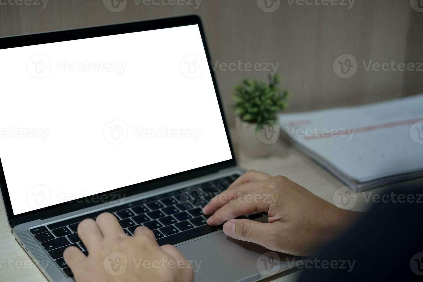 person hand using keyboard laptop computer mock up blank white screen on desk. photo
