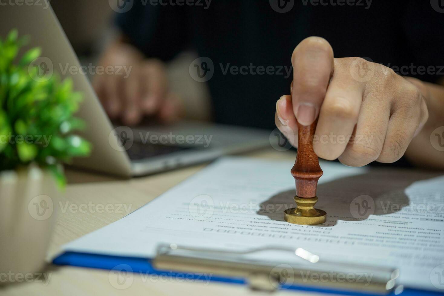 Contract law or paper work business and finance document rubber stamp. For official and legal contracts and agreements, financial statements, investment contracts, real estate documents. photo