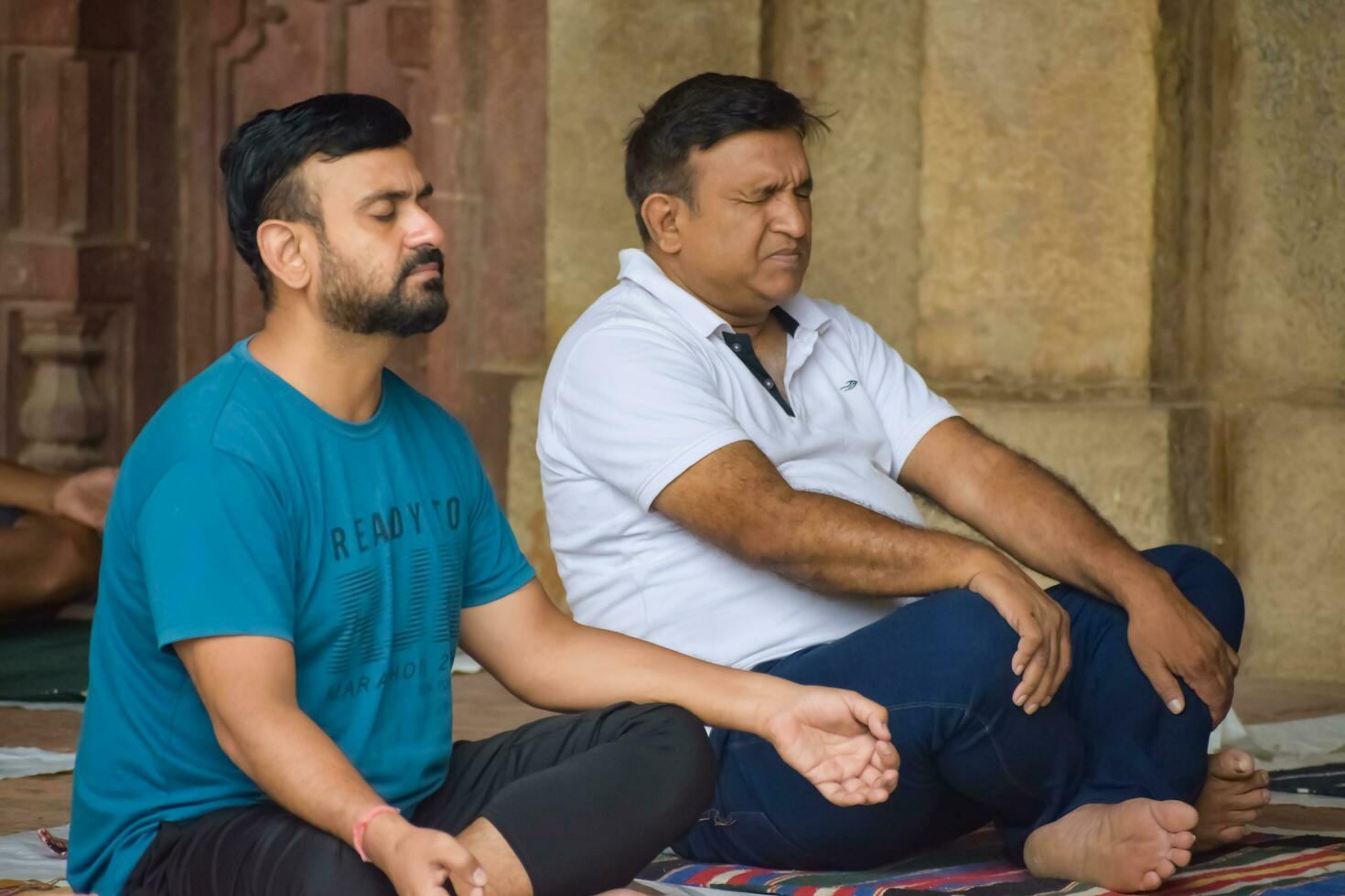 New Delhi, India, May 31 2023 - Group Yoga exercise class for people of different age in Lodhi Garden, International Yoga Day, Big group of adults attending a yoga class in park photo