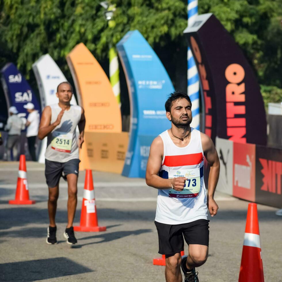 New Delhi, India - June 16 2023 - Vedanta Delhi Half Marathon race after covid in which marathon participants about to cross the finish line, Delhi Half Marathon 2022 photo