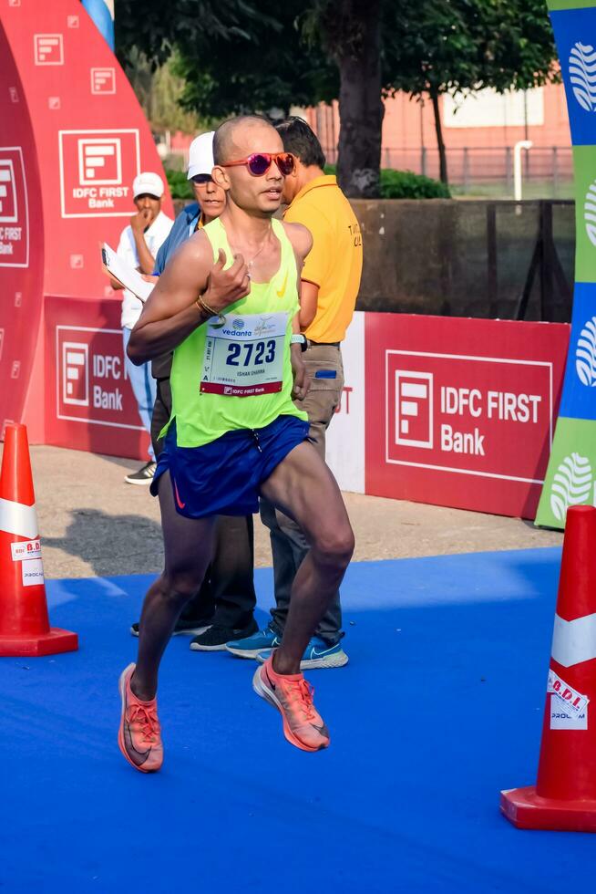 New Delhi, India - July 16 2023 - Vedanta Delhi Half Marathon race after covid in which marathon participants about to cross the finish line, Delhi Half Marathon 2022 photo