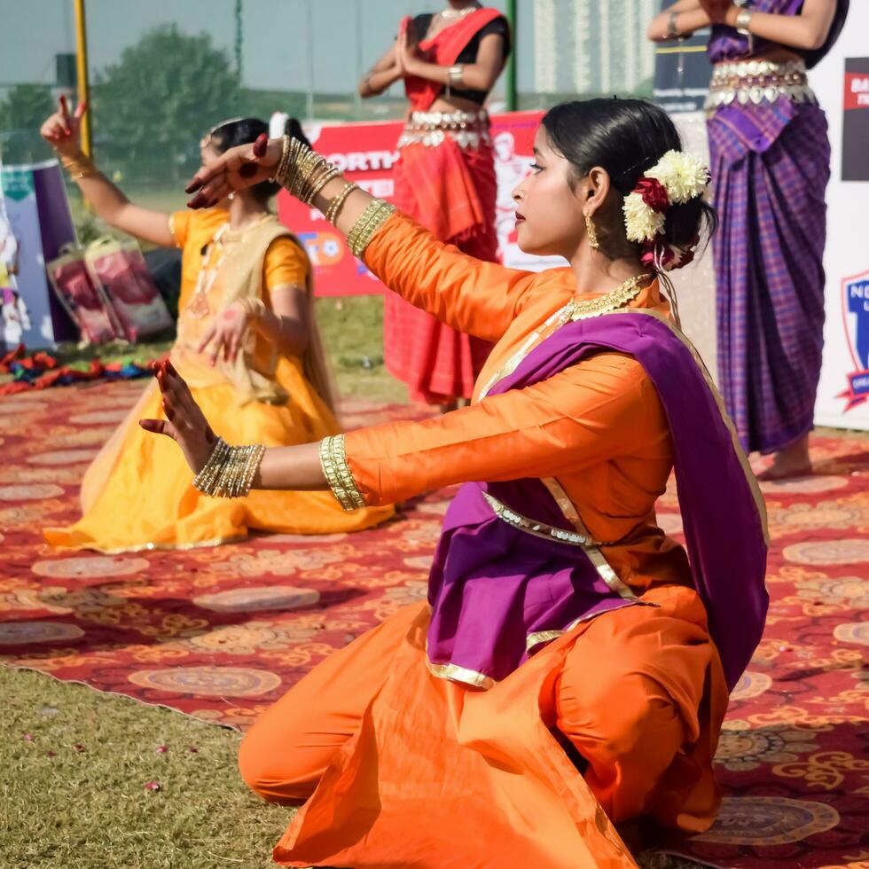 New Delhi, India - July 01 2023 - Bharathanatyam Indian classical odissi dancers performing at stage. Beautiful Indian girl dancers in the posture of Indian dance. Indian classical dance Bharatanatyam photo