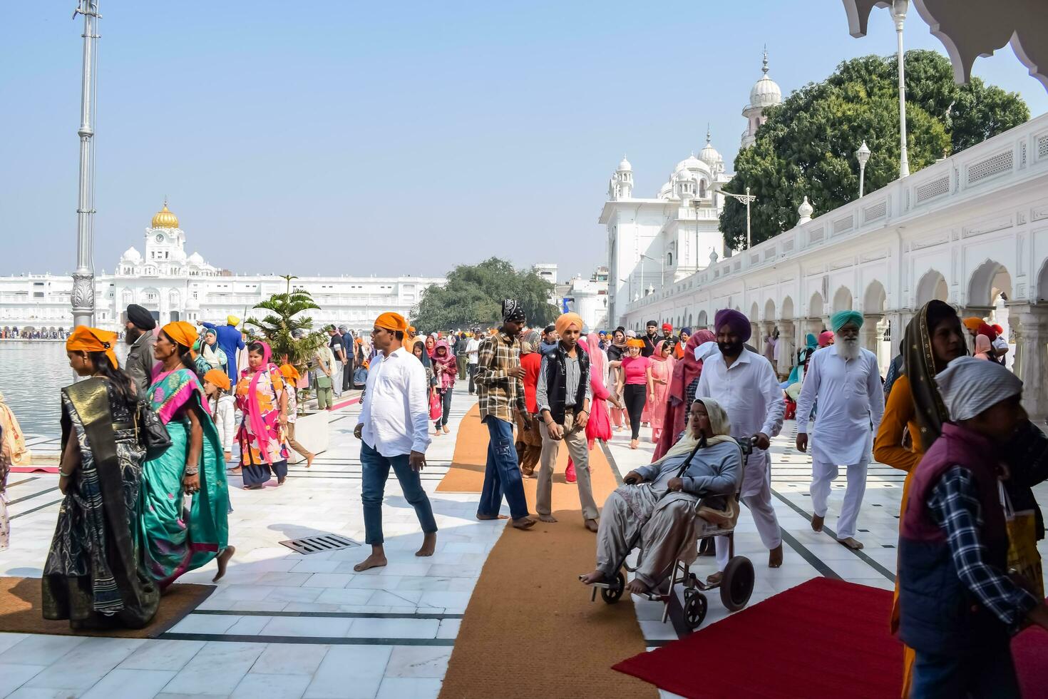 Amritsar, India - February 26 2023 - Unidentified devotees from various parts at Golden Temple Harmandir Sahib in Amritsar, Punjab, India, Famous indian sikh landmark, Golden Temple photo