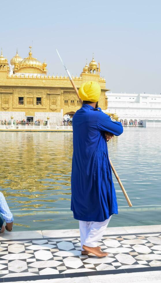 Amritsar, India - February 26 2023 - Unidentified devotees from various parts at Golden Temple Harmandir Sahib in Amritsar, Punjab, India, Famous indian sikh landmark, Golden Temple photo