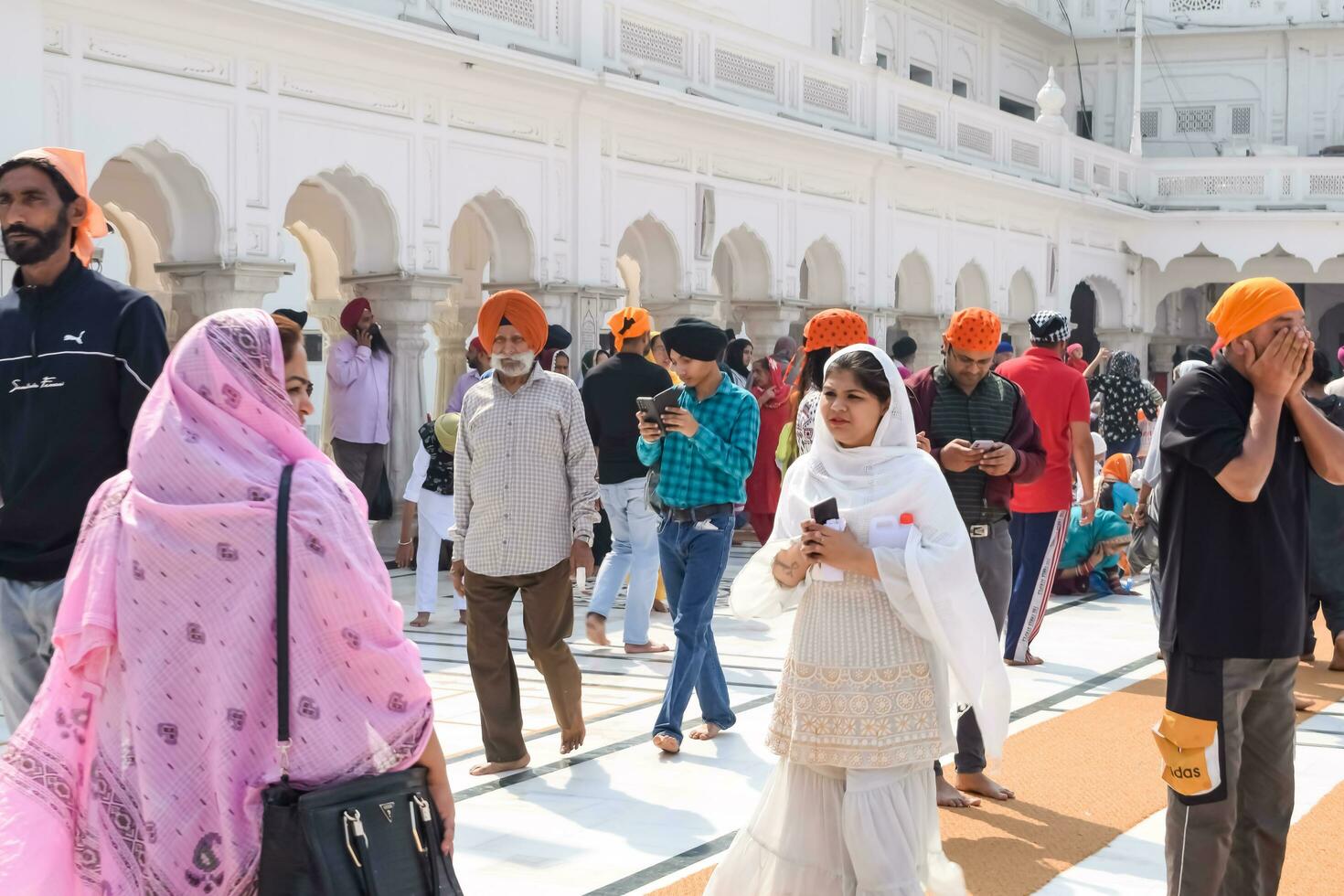 Amritsar, India - February 26 2023 - Unidentified devotees from various parts at Golden Temple Harmandir Sahib in Amritsar, Punjab, India, Famous indian sikh landmark, Golden Temple photo