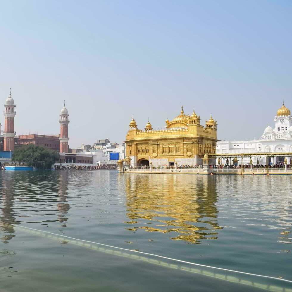 Amritsar, India - May 31 2023 - Beautiful view of Golden Temple - Harmandir Sahib in Amritsar, Punjab, India, Famous indian sikh landmark, Golden Temple, the main sanctuary of Sikhs in Amritsar, India photo