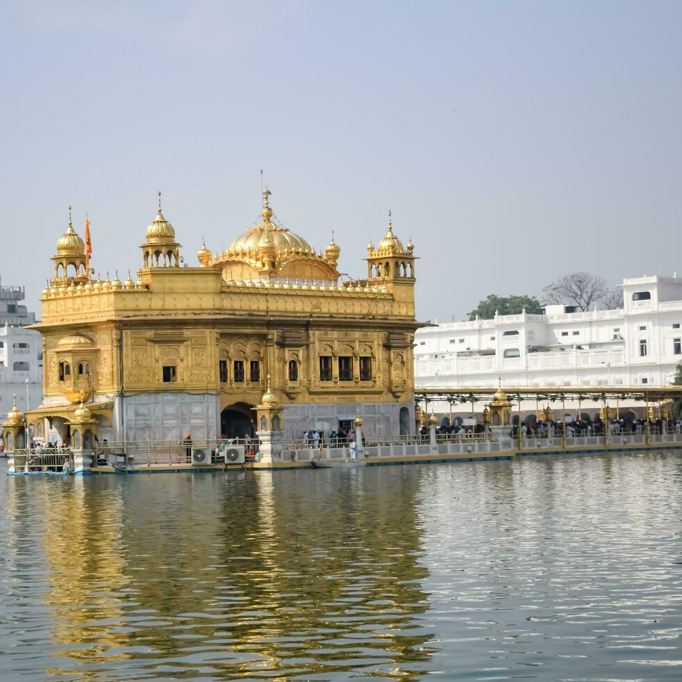 Amritsar, India - May 31 2023 - Beautiful view of Golden Temple - Harmandir Sahib in Amritsar, Punjab, India, Famous indian sikh landmark, Golden Temple, the main sanctuary of Sikhs in Amritsar, India photo