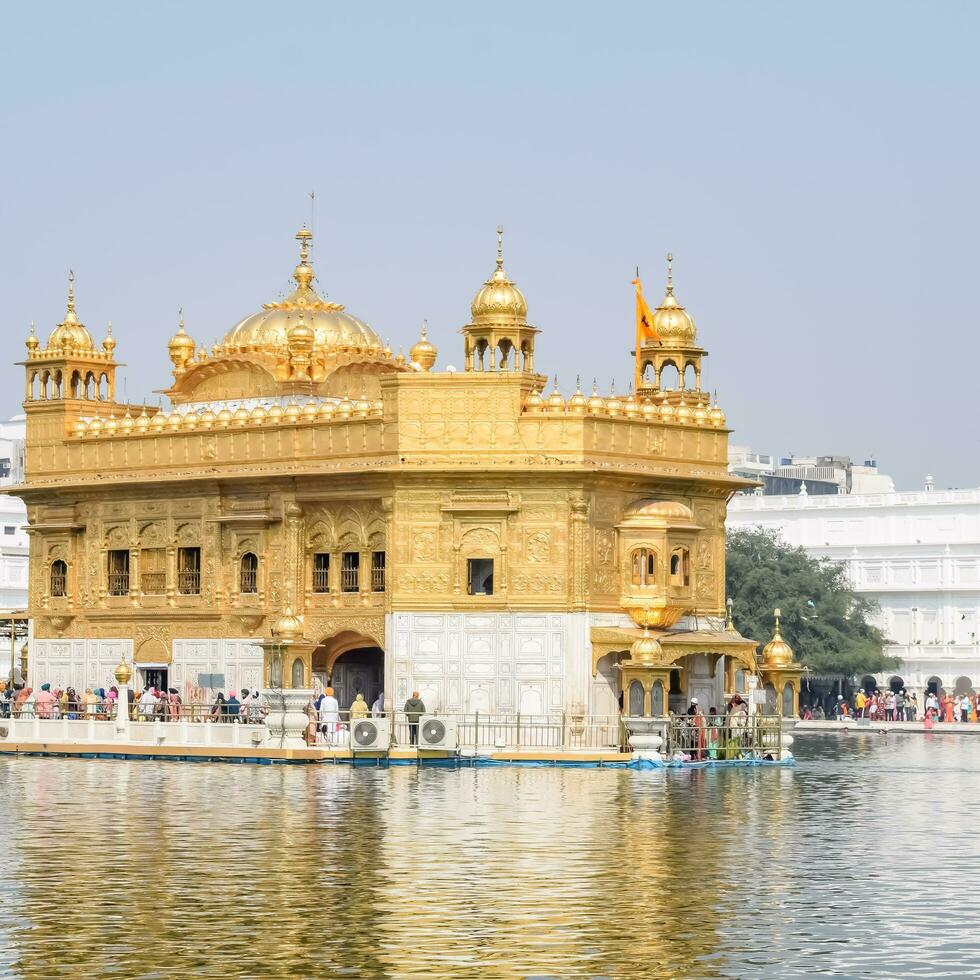 Amritsar, India - May 31 2023 - Beautiful view of Golden Temple - Harmandir Sahib in Amritsar, Punjab, India, Famous indian sikh landmark, Golden Temple, the main sanctuary of Sikhs in Amritsar, India photo