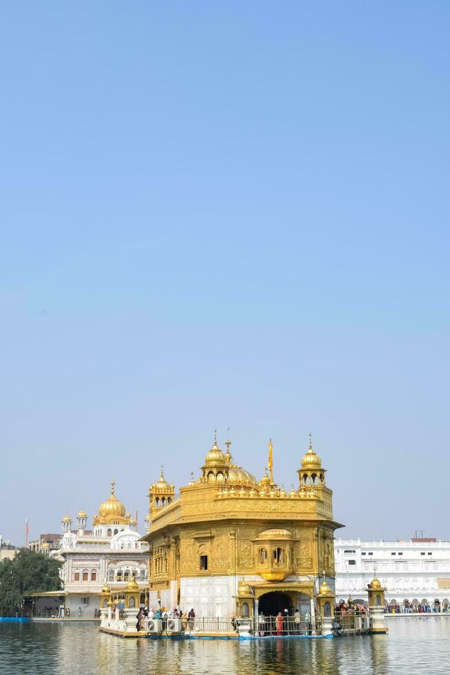 Amritsar, India - May 31 2023 - Beautiful view of Golden Temple - Harmandir Sahib in Amritsar, Punjab, India, Famous indian sikh landmark, Golden Temple, the main sanctuary of Sikhs in Amritsar, India photo