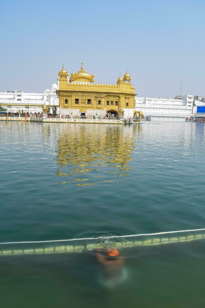 Amritsar, India - May 31 2023 - Beautiful view of Golden Temple - Harmandir Sahib in Amritsar, Punjab, India, Famous indian sikh landmark, Golden Temple, the main sanctuary of Sikhs in Amritsar, India photo