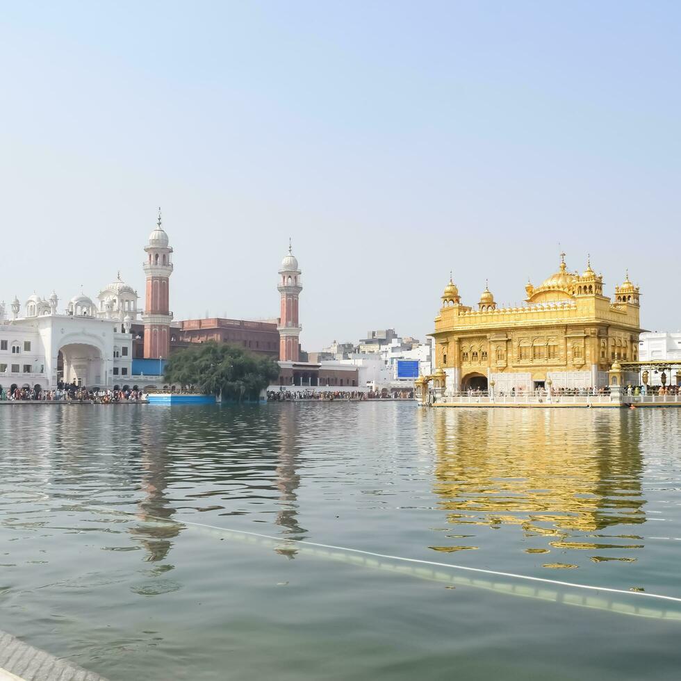 Amritsar, India - May 31 2023 - Beautiful view of Golden Temple - Harmandir Sahib in Amritsar, Punjab, India, Famous indian sikh landmark, Golden Temple, the main sanctuary of Sikhs in Amritsar, India photo