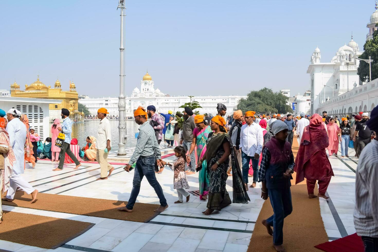 Amritsar, India - February 26 2023 - Unidentified devotees from various parts at Golden Temple Harmandir Sahib in Amritsar, Punjab, India, Famous indian sikh landmark, Golden Temple photo
