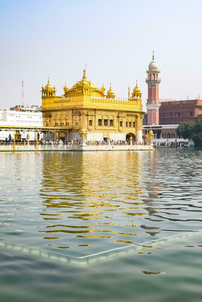 Amritsar, India - May 31 2023 - Beautiful view of Golden Temple - Harmandir Sahib in Amritsar, Punjab, India, Famous indian sikh landmark, Golden Temple, the main sanctuary of Sikhs in Amritsar, India photo