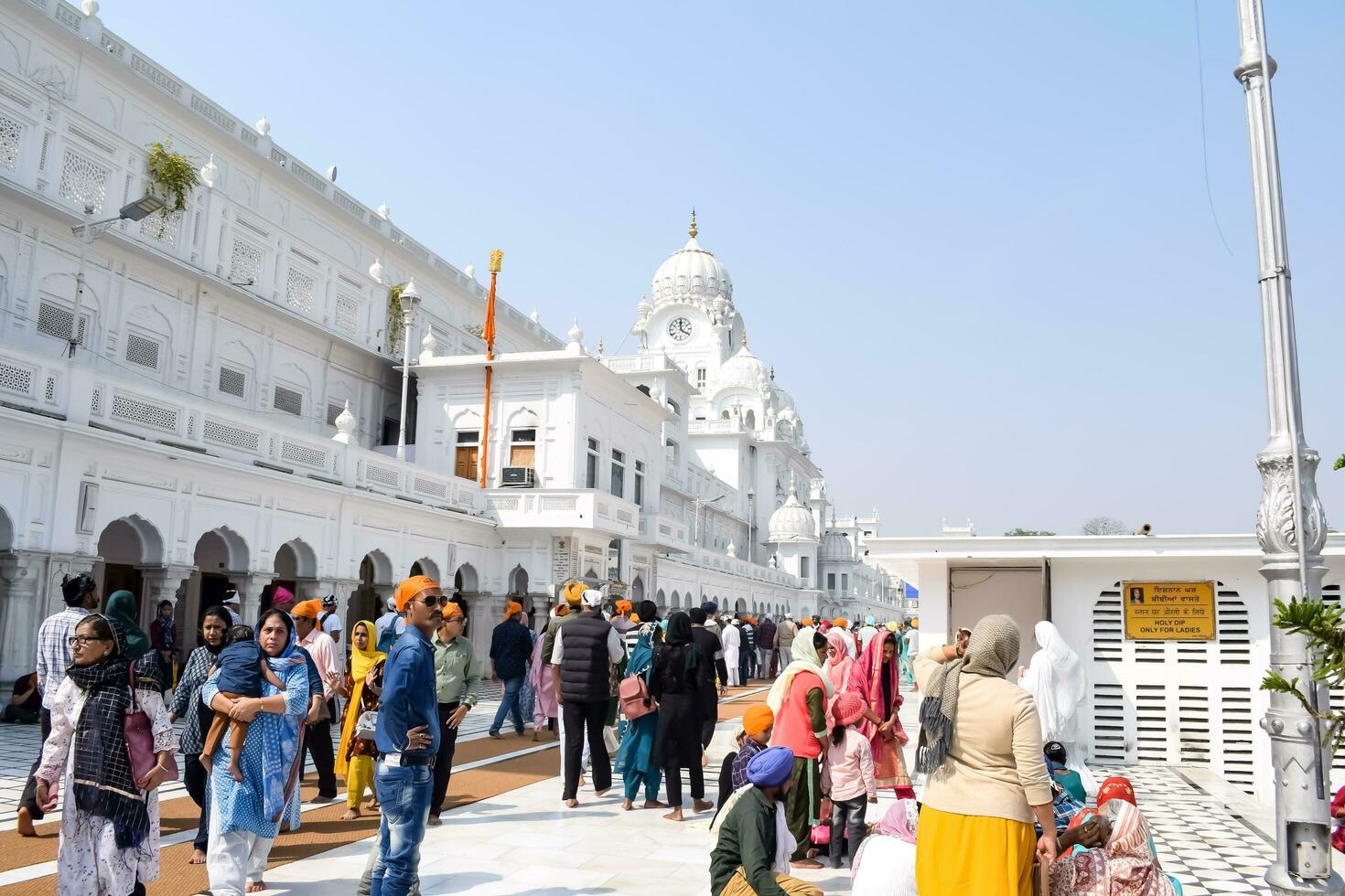 Amritsar, India - February 26 2023 - Unidentified devotees from various parts at Golden Temple Harmandir Sahib in Amritsar, Punjab, India, Famous indian sikh landmark, Golden Temple photo